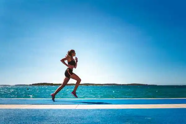 Woman running showing strong leg muscle Bicester